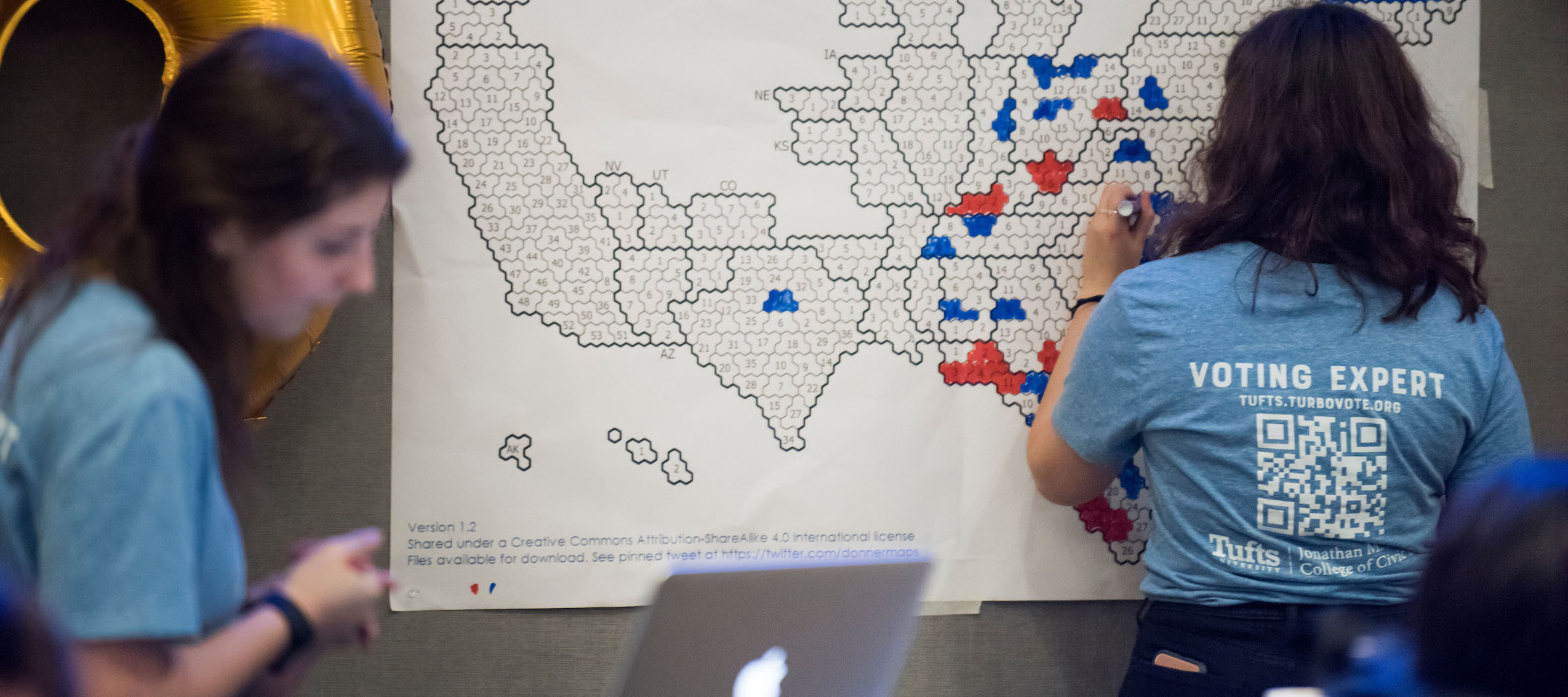 Young people filling in an election results map