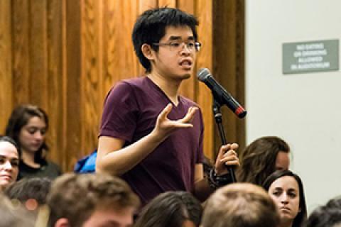 Young man speaking at a microphone