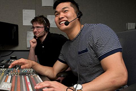 Young man and supervisor at digital switchboard